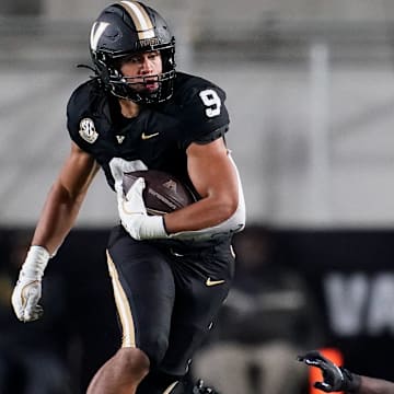 Vanderbilt tight end Eli Stowers (9) evades Ball State defensive back George Udo (10) during the fourth quarter at FirstBank Stadium in Nashville, Tenn., Saturday, Oct. 19, 2024.