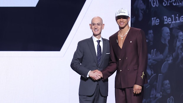 Carter Bryant stands with the NBA commissioner, Adam Silver, after being selected as 14th choice by the San Antonio Spurs in the 