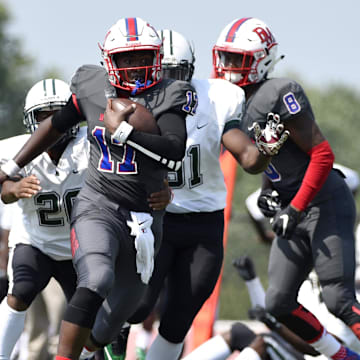 Hyattsville, MD, USA; DeMatha Stags quarterback runs the ball into the end zone 
