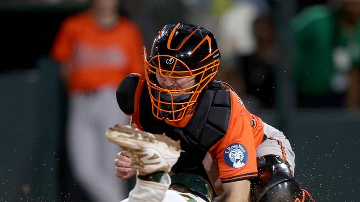 Jun 7, 2025; West Sacramento, California, USA; Baltimore Orioles catcher Maverick Handley (98) covers home plate as Athletics left fielder JJ Bleday (33) slides home during the fifth inning at Sutter Health Park. Mandatory Credit: Dennis Lee-Imagn Images