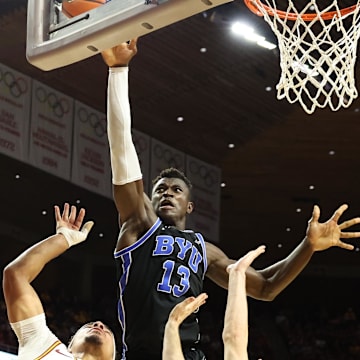 Mar 4, 2025; Ames, Iowa, USA; Brigham Young Cougars center Keba Keita (13) blocks the shot from Iowa State Cyclones guard Tamin Lipsey (3) at James H. Hilton Coliseum. Mandatory Credit: Reese Strickland-Imagn Images