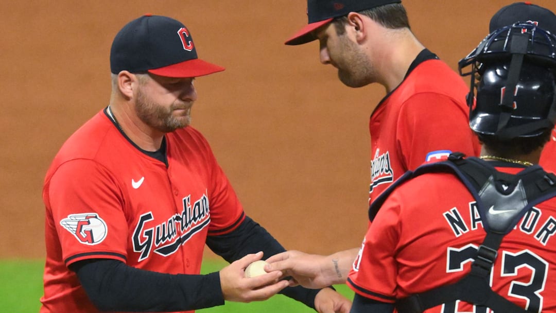 Sep 12, 2024; Cleveland, Ohio, USA; Cleveland Guardians manager Stephen Vogt (12) takes the ball from starting pitcher Gavin Williams (32) during a pitching change in the sixth inning against the Tampa Bay Rays at Progressive Field.