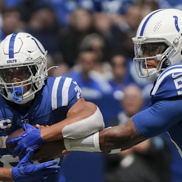 Indianapolis Colts quarterback Anthony Richardson (5) hands the ball off to Indianapolis Colts running back Jonathan Taylor (28) at Lucas Oil Stadium.