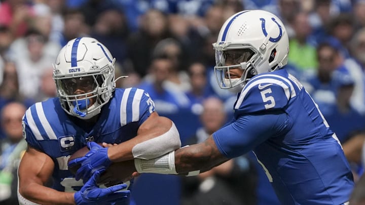 Indianapolis Colts quarterback Anthony Richardson (5) hands the ball off to Indianapolis Colts running back Jonathan Taylor (28) at Lucas Oil Stadium.