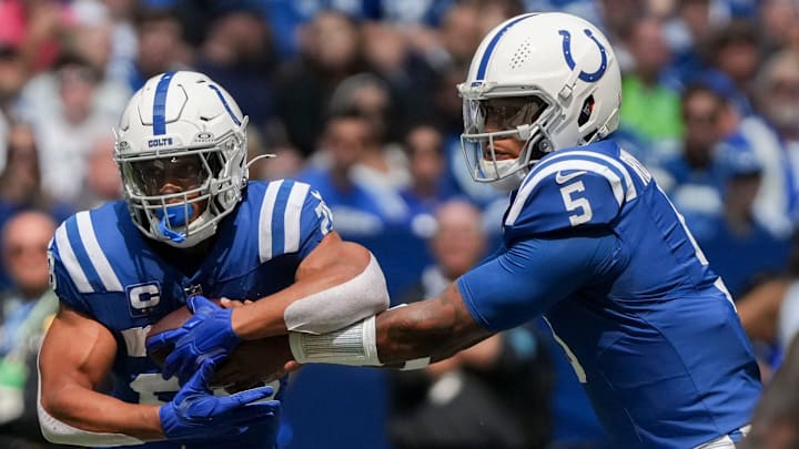 Indianapolis Colts quarterback Anthony Richardson (5) hands the ball off to Indianapolis Colts running back Jonathan Taylor.