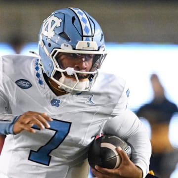 Oct 17, 2025; Berkeley, California, USA; North Carolina Tar Heels quarterback Gio Lopez (7) evades tackle by California Golden Bears linebacker Cade Uluave (0) in the second quarter at California Memorial Stadium. 