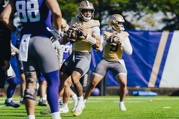 Demond Williams Jr. looks for a receiver while throwing next to Dash Beierly in spring ball. 