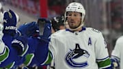 Jan 15, 2023; Raleigh, North Carolina, USA;  Vancouver Canucks center J.T. Miller (9) celebrates his goals against the Carolina Hurricanes during the third period at PNC Arena. Mandatory Credit: James Guillory-Imagn Images