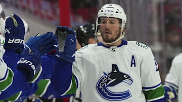 Jan 15, 2023; Raleigh, North Carolina, USA;  Vancouver Canucks center J.T. Miller (9) celebrates his goals against the Carolina Hurricanes during the third period at PNC Arena. Mandatory Credit: James Guillory-Imagn Images