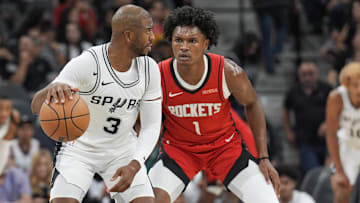 Oct 26, 2024; San Antonio, Texas, USA;  San Antonio Spurs guard Chris Paul (3) dribbles against Houston Rockets forward Amen Thompson (1) in the first half at Frost Bank Center. Mandatory Credit: Daniel Dunn-Imagn Images