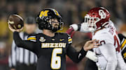 Nov 9, 2024; Columbia, Missouri, USA; Missouri Tigers quarterback Drew Pyne (6) throws a pass against Oklahoma Sooners defensive lineman Ethan Downs (40) during the second half at Faurot Field at Memorial Stadium. 