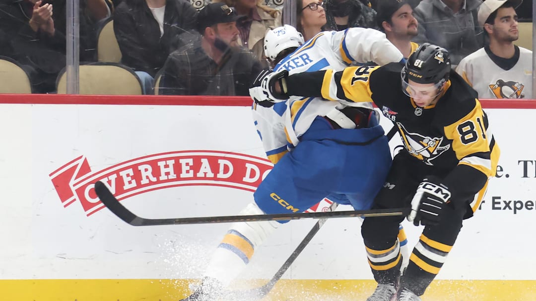 Oct 27, 2025; Pittsburgh, Pennsylvania, USA; Pittsburgh Penguins center Ben Kindel (81) attempts to get around St. Louis Blues defenseman Tyler Tucker (75) during the third period at PPG Paints Arena. Mandatory Credit: Charles LeClaire-Imagn Images