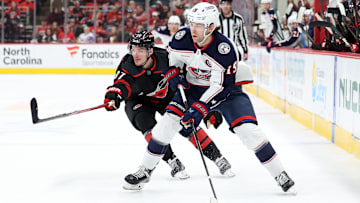 Blue Jackets center Adam Fantilli tries to make a play against Hurricanes forward Andrei Svechnikov.