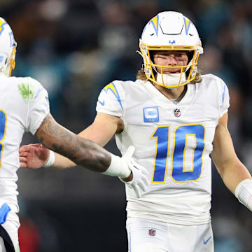 Jan 14, 2023; Jacksonville, Florida, USA; Los Angeles Chargers quarterback Justin Herbert (10) and wide receiver Keenan Allen (13) celebrate after a play during the second quarter a wild card game against the Jacksonville Jaguars at TIAA Bank Field. Mandatory Credit: Nathan Ray Seebeck-Imagn Images