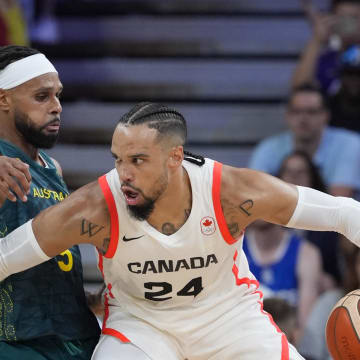 Jul 30, 2024; Villeneuve-d'Ascq, France; Canada small forward Dillon Brooks (24) posts up against Australia guard Patty Mills (5) in a men's group stage basketball match during the Paris 2024 Olympic Summer Games at Stade Pierre-Mauroy. Mandatory Credit: John David Mercer-USA TODAY Sports