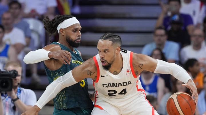 Jul 30, 2024; Villeneuve-d'Ascq, France; Canada small forward Dillon Brooks (24) posts up against Australia guard Patty Mills (5) in a men's group stage basketball match during the Paris 2024 Olympic Summer Games at Stade Pierre-Mauroy. Mandatory Credit: John David Mercer-USA TODAY Sports