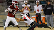 Raines High School running back Tadarius Washington (5) sheds Bishop Kenny Austin Green (8) in the second quarter. Raines High School hosted Bishop Kenny in the Class 3A high school football playoffs at Raines High School Friday night, November 28, 2025 in Jacksonville, Fla. Raines defeated Bishop Kenny 61-15. [Doug Engle/Florida Times-Union]