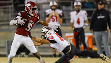 Raines High School running back Tadarius Washington (5) sheds Bishop Kenny Austin Green (8) in the second quarter. Raines High School hosted Bishop Kenny in the Class 3A high school football playoffs at Raines High School Friday night, November 28, 2025 in Jacksonville, Fla. Raines defeated Bishop Kenny 61-15. [Doug Engle/Florida Times-Union]