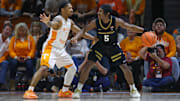 Feb 17, 2024; Knoxville, Tennessee, USA; Vanderbilt Commodores guard Ezra Manjon (5) moves the ball against  Tennessee Volunteers guard Zakai Zeigler (5) during the second half at Thompson-Boling Arena at Food City Center.