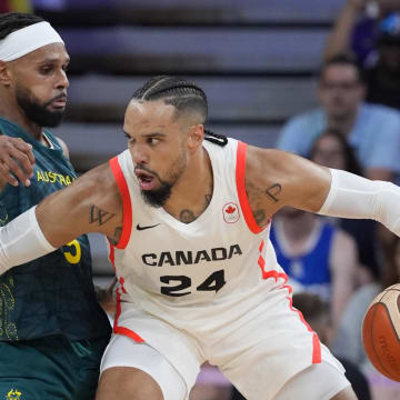 Jul 30, 2024; Villeneuve-d'Ascq, France; Canada small forward Dillon Brooks (24) posts up against Australia guard Patty Mills (5) in a men's group stage basketball match during the Paris 2024 Olympic Summer Games at Stade Pierre-Mauroy. Mandatory Credit: John David Mercer-USA TODAY Sports
