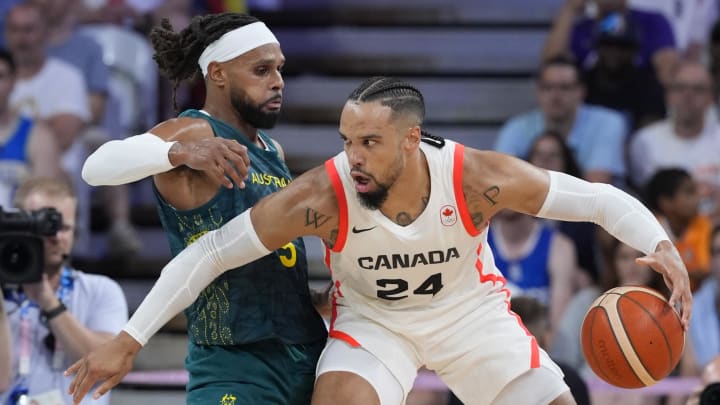 Jul 30, 2024; Villeneuve-d'Ascq, France; Canada small forward Dillon Brooks (24) posts up against Australia guard Patty Mills (5) in a men's group stage basketball match during the Paris 2024 Olympic Summer Games at Stade Pierre-Mauroy. Mandatory Credit: John David Mercer-USA TODAY Sports