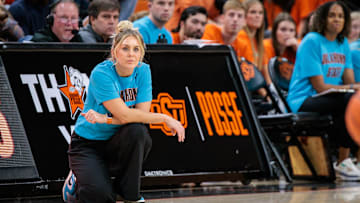Nov 9, 2025; Stillwater, Oklahoma, USA; Oklahoma State Cowgirls coach Jaycie Hoyt watches game play during the first half against the Oral Roberts Golden Eagles at Gallagher-Iba Arena. Mandatory Credit: William Purnell-Imagn Images