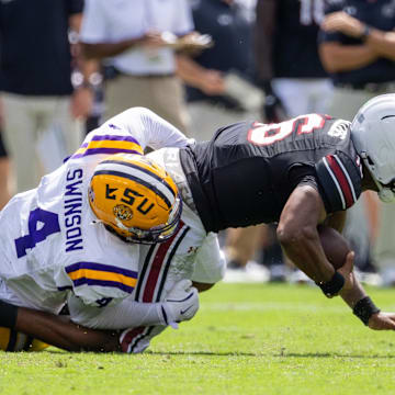 Sep 14, 2024; Columbia, South Carolina, USA; LSU Tigers defensive end Bradyn Swinson (4) sacks South Carolina Gamecocks quarterback LaNorris Sellers (16) during the second quarter at Williams-Brice Stadium. Mandatory Credit: Scott Kinser-Imagn Images