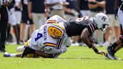 Sep 14, 2024; Columbia, South Carolina, USA; LSU Tigers defensive end Bradyn Swinson (4) sacks South Carolina Gamecocks quarterback LaNorris Sellers (16) during the second quarter at Williams-Brice Stadium. Mandatory Credit: Scott Kinser-Imagn Images