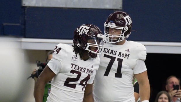 Texas A&M Aggies running back Earnest Crownover (24) and offensive lineman Chase Bisontis (71) celebrate. 