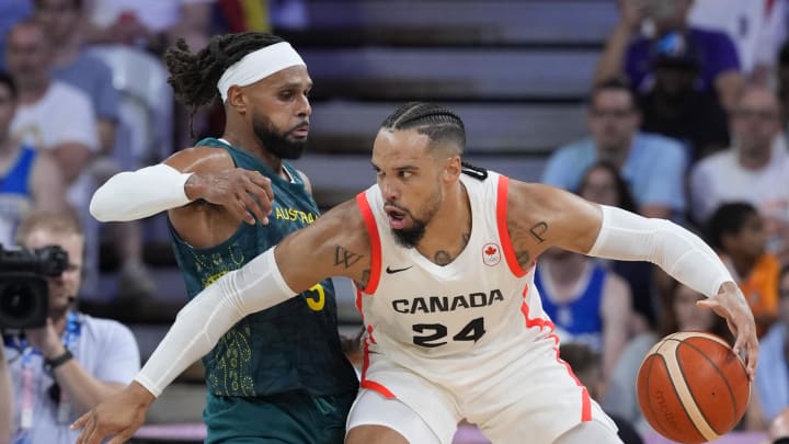 Jul 30, 2024; Villeneuve-d'Ascq, France; Canada small forward Dillon Brooks (24) posts up against Australia guard Patty Mills (5) in a men's group stage basketball match during the Paris 2024 Olympic Summer Games at Stade Pierre-Mauroy. Mandatory Credit: John David Mercer-USA TODAY Sports