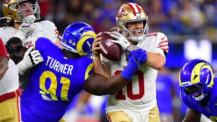 San Francisco quarterback Mac Jones was roughed up against the Rams on Thursday night, but still found a way to lead the 49ers to a win in overtime.
