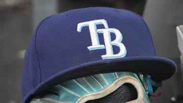 Sep 26, 2025; Toronto, Ontario, CAN; The hat and glove of Tampa Bay Rays third baseman Junior Caminero (13) in the dugout during the game against the Toronto Blue Jays at Rogers Centre. 