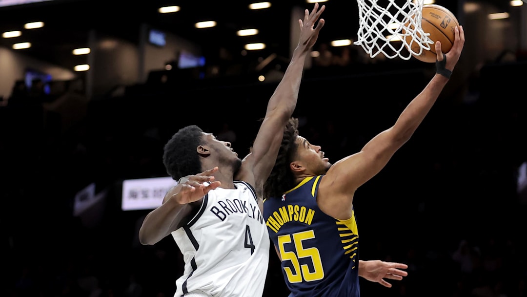 Feb 11, 2026; Brooklyn, New York, USA; Indiana Pacers guard Ethan Thompson (55) drives to the basket against Brooklyn Nets guard Drake Powell (4) during the third quarter at Barclays Center. Mandatory Credit: Brad Penner-Imagn Images