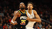 Dec 3, 2024; Phoenix, Arizona, USA; Phoenix Suns forward Kevin Durant (35) against San Antonio Spurs center Victor Wembanyama (1) in the first half of an NBA Cup game at Footprint Center. Mandatory Credit: Mark J. Rebilas-Imagn Images