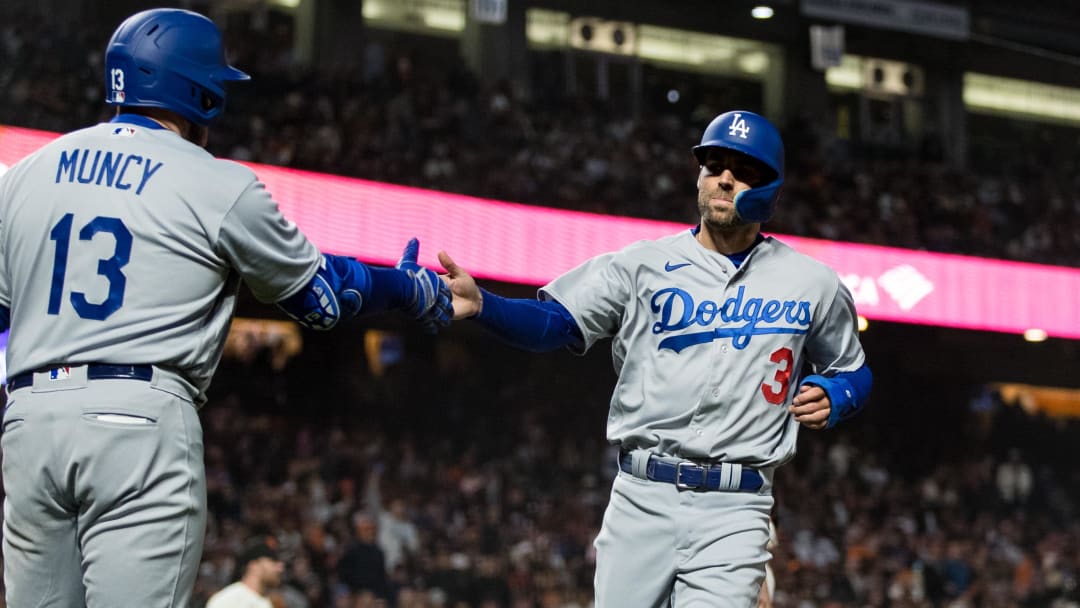 Apr 12, 2023; San Francisco, California, USA;  Los Angeles Dodgers left fielder Chris Taylor (3) is congratulated by third baseman Max Muncy (13) after he scored against the San Francisco Giants during the sixth inning at Oracle Park. Mandatory Credit: John Hefti-USA TODAY Sports