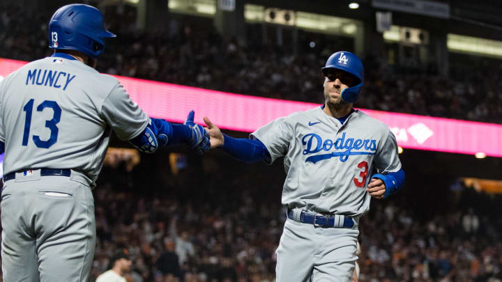 Apr 12, 2023; San Francisco, California, USA;  Los Angeles Dodgers left fielder Chris Taylor (3) is congratulated by third baseman Max Muncy (13) after he scored against the San Francisco Giants during the sixth inning at Oracle Park. Mandatory Credit: John Hefti-USA TODAY Sports