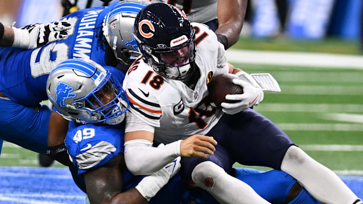 Nov 28, 2024; Detroit, Michigan, USA; Chicago Bears quarterback Caleb Williams (18) is sacked by Detroit Lions defensive end Za'Darius Smith (99) in the fourth quarter at Ford Field. Mandatory Credit: Lon Horwedel-Imagn Images