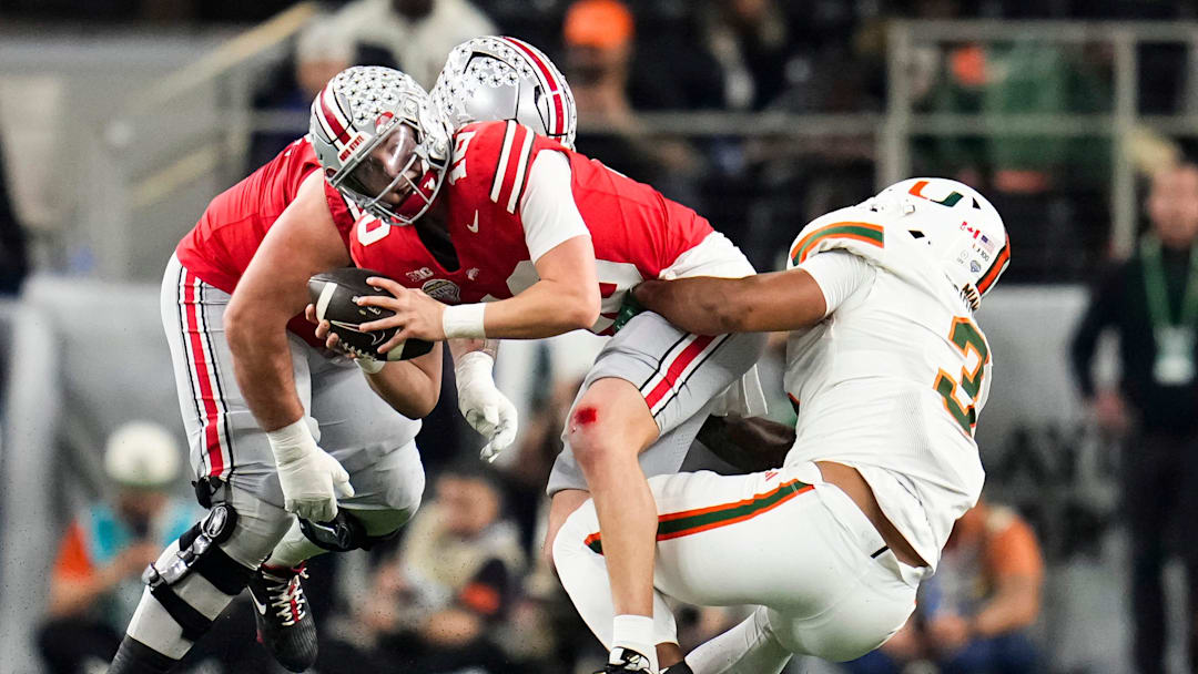 Miami Hurricanes defensive lineman Akheem Mesidor (3) hits Ohio State Buckeyes quarterback Julian Sayin (10) during the Cotton Bowl at AT&T Stadium in Arlington, Texas for the College Football Playoff quarterfinal game on Dec. 31, 2025.