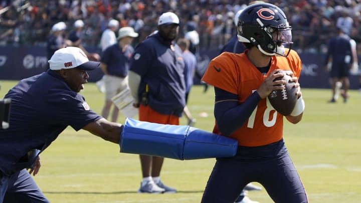 Caleb Williams works at pocket presence and avoiding the rush during pre-practice warmups.