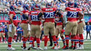 Sep 8, 2024; East Rutherford, New Jersey, USA; New York Giants offensive linemen huddle during the first quarter against the Minnesota Vikings at MetLife Stadium.  