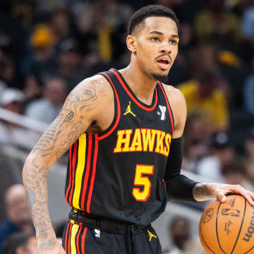 Apr 14, 2024; Indianapolis, Indiana, USA; Atlanta Hawks guard Dejounte Murray (5) dribbles the ball while Indiana Pacers guard Ben Sheppard (26) defends in the second half at Gainbridge Fieldhouse.