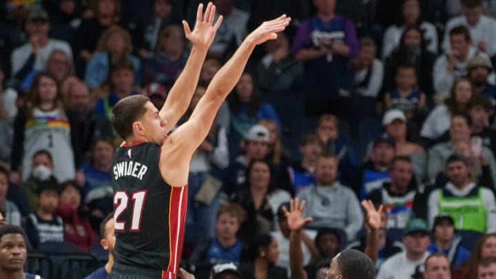 Oct 28, 2023; Minneapolis, Minnesota, USA; Miami Heat forward Cole Swider (21) shoots over Minnesota Timberwolves guard Shake Milton (18) in the fourth quarter at Target Center. Mandatory Credit: Matt Blewett-USA TODAY Sports