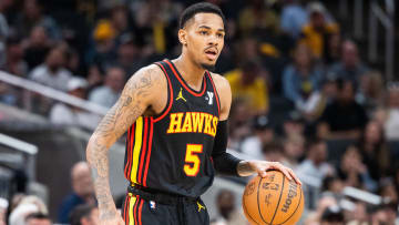 Apr 14, 2024; Indianapolis, Indiana, USA; Atlanta Hawks guard Dejounte Murray (5) dribbles the ball while Indiana Pacers guard Ben Sheppard (26) defends in the second half at Gainbridge Fieldhouse. Mandatory Credit: Trevor Ruszkowski-USA TODAY Sports