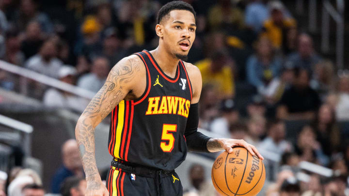 Apr 14, 2024; Indianapolis, Indiana, USA; Atlanta Hawks guard Dejounte Murray (5) dribbles the ball while Indiana Pacers guard Ben Sheppard (26) defends in the second half at Gainbridge Fieldhouse.