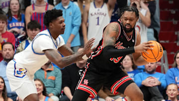 Jan 25, 2025; Lawrence, Kansas, USA; Houston Cougars forward J'Wan Roberts (13) controls the ball as Kansas Jayhawks guard AJ Storr (2) defends during the second half at Allen Fieldhouse. Mandatory Credit: Denny Medley-Imagn Images