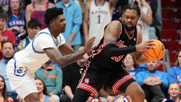 Jan 25, 2025; Lawrence, Kansas, USA; Houston Cougars forward J'Wan Roberts (13) controls the ball as Kansas Jayhawks guard AJ Storr (2) defends during the second half at Allen Fieldhouse. Mandatory Credit: Denny Medley-Imagn Images