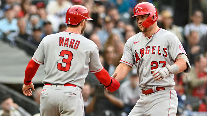 Jun 16, 2022; Seattle, Washington, USA; Los Angeles Angels center fielder Mike Trout (27) and right fielder Taylor Ward (3) celebrate at home plate after Trout hit a two-run home run against the Seattle Mariners during the third inning at T-Mobile Park. Mandatory Credit: Steven Bisig-Imagn Images