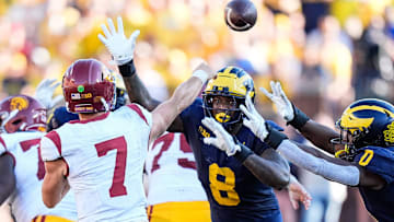 USC quarterback Miller Moss (7) makes a pass against Michigan defensive end Derrick Moore (8) during the second half at Michigan Stadium in Ann Arbor on Saturday, Sept. 21, 2024.