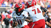 Sep 20, 2025; Durham, North Carolina, USA;  North Carolina State Wolfpack quarter back CJ Bailey (11) runs the ball against the Duke Blue Devils during the first quarter at Wallace Wade Stadium. Mandatory Credit: Zachary Taft-Imagn Images