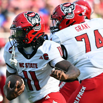Sep 20, 2025; Durham, North Carolina, USA;  North Carolina State Wolfpack quarter back CJ Bailey (11) runs the ball against the Duke Blue Devils during the first quarter at Wallace Wade Stadium. Mandatory Credit: Zachary Taft-Imagn Images